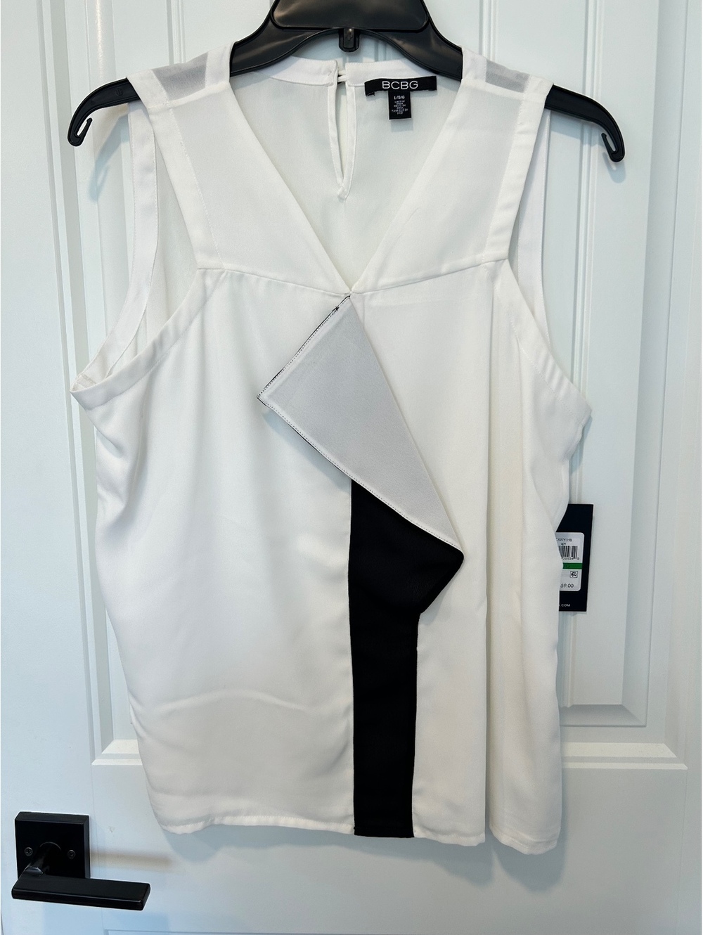 BCBG NWT cream sleeveless blouse with black fabric details in the front